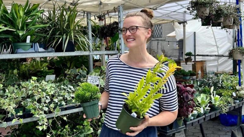 Laura Allen holding plants at the farmers market